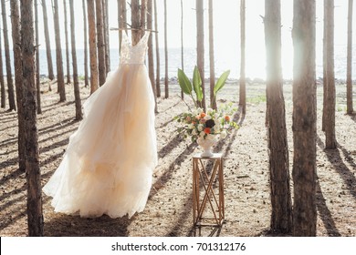 Tulle Wedding Dress And Flower Wedding Decoration In Boho Style In The Forest. 