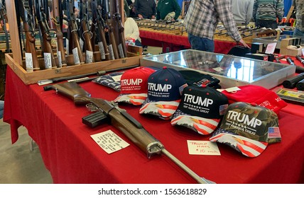Tulsa, Oklahoma - November 9, 2019: "Keep America Great" hats for sale supporting President Trump with gun display.