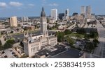 Tulsa, Oklahoma, USA - June 25, 2023: Afternoon sun shines on historic buildings of downtown Tulsa.