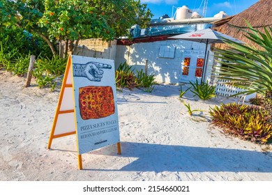 Tulum Mexico 02. February 2022 Buy and eat pizza at the amazing and beautiful caribbean coast and beach panorama view with turquoise water people and huts of Tulum in Quintana Roo Mexico.