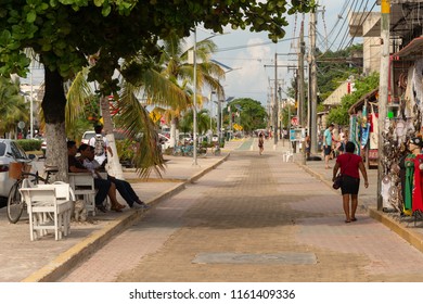 Tulum, Mexico - 7 August 2018: People Walking On The Sidewalk On Avenida Tulum.