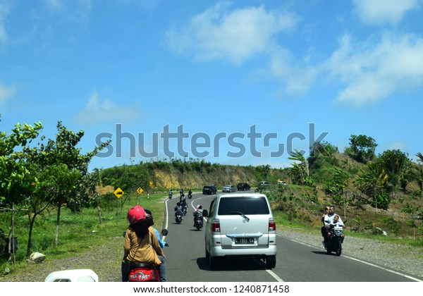 Tulungagung, Indonesia - November 20, 2018:\
Cars pass on beautiful mountain roads in the southern crossroad in\
Tulungagung (JLS), East Java,\
Indonesia