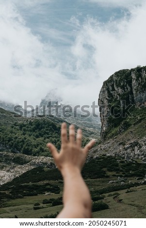 Tumblr style image hand over Idyllic mountain scenery in spain with blooming meadows in springtime, freedom , liberty and peace concepts