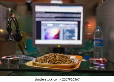 TUMEN, JILIN, CHINA - APRIL 2008 : Typical Cybercafe Desk In Yanbian Korean Autonomous Prefecture (Yeonbyeon), With Big Plate Of Fried Noodles, Computer Screen And Cigarettes