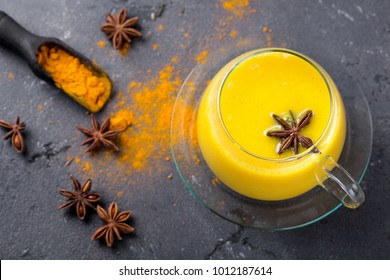 Tumeric Milk Chai Served With Cinnamon, Anise And Tumeric Root And Powder. Copy Space. Top View