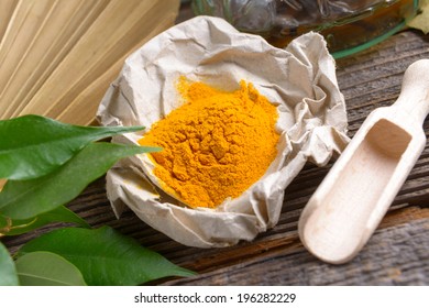 Tumeric Powder Spice On Wooden Board 