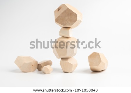 Tumi-ishi puzzle game. Construction of an unstable wooden block tower. The process of the game. Stones for Rock Balance.
