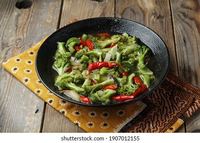 Tumis brokoli or sauteed spicy broccoli served in a bowl - Shutterstock ID 1907012155