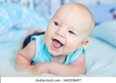 Tummy Time! Happy Baby Boy Enjoying Lying On Stomach And Learning To Roll