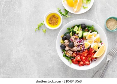 Tuna And Fresh Vegetable Salad Of Tomato, Cucumber, Olives, Onion, Lettuce And Boiled Egg, Top View. Easter Salad