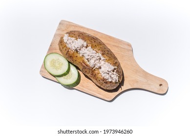 Tuna Jacket Potato With Cucumber On Cutting Board.