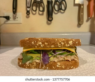 Tuna And Muenster Cheese Sandwich On Kitchen Counter Among Utensils