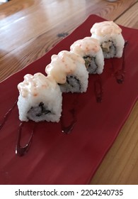 Tuna And Nori Roll Sushi In The Red Plate On The Wooden Table. With Spicy Sauce.