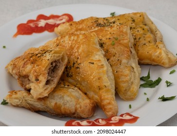 Tuna puff pasty on a white plate with chili sauce. A delicious savory pastry for daily breakfast or snacks. Selective Focus. Close Up - Shutterstock ID 2098024447