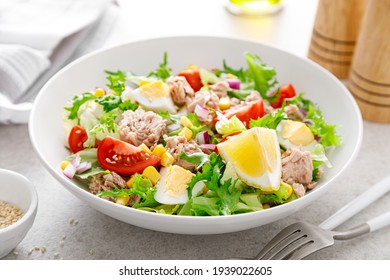 Tuna salad with boiled egg, tomato, lettuce, corn and red onion. Healthy and detox food concept. Ketogenic diet. Fresh vegetable salad bowl on white background - Powered by Shutterstock