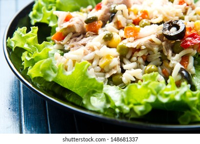 Tuna Salad With Rice And Vegetables On Black Dish