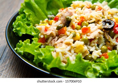 Tuna Salad With Rice And Vegetables On Black Dish 