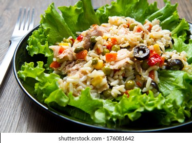 Tuna Salad With Rice And Vegetables On Black Dish 