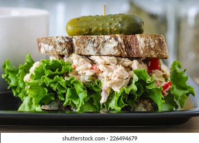 Tuna Salad Sandwich With Lettuce On Rye Toast With Butternut Squash Soup, Potato Chips, And A Pickle