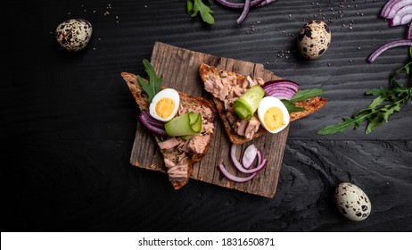 Tuna Salad Sandwiches On Chopping Board. Bruschetta Toast With Wholemeal Bread, Canned Tuna Fish, Quail Eggs And Onions, Cucumber.