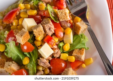 Tuna Salad With Tomatoes, Feta Cheese, Corn And Greens On Plate