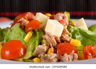 Tuna Salad With Tomatoes, Feta Cheese, Corn And Greens On Plate