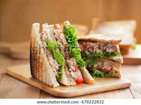 tuna sandwich on wooden board