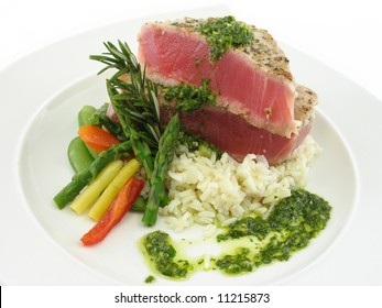 Tuna steak on a white plate isolated on white.