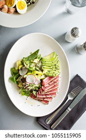 Tuna Steak Salad With Sliced Avocado And Lettuce Overhead View