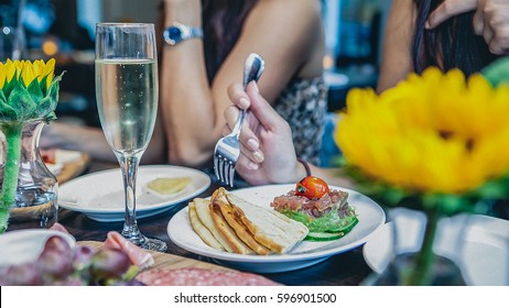 Tuna Tartar Is Served With Avocado, A Side Of Pita Bread And A Glass Of Champagne