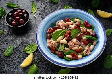 Tuna, White Bean Salad With Olive, Red Onion, Spinach And Dried Tomato. Healthy Food.