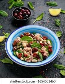 Tuna, White Bean Salad With Olive, Red Onion, Spinach And Dried Tomato. Healthy Food.