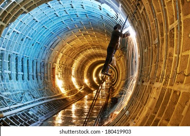 Tuneller welder working and electrode at arc welding in underground subway metro construction site