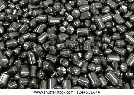 Tungsten cylinders. Ingots of tungsten in a pile