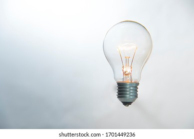 Tungsten Light Bulb Lighten On White Background