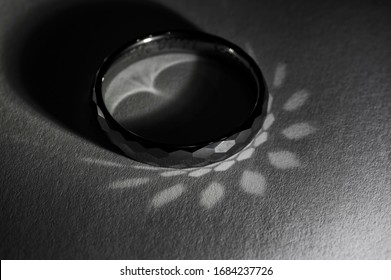 Tungsten Ring Lying With Light Reflection.