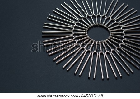 Tuning fork round pattern on a black background