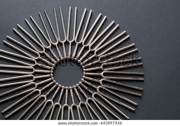 Tuning fork\
round pattern on a black\
background