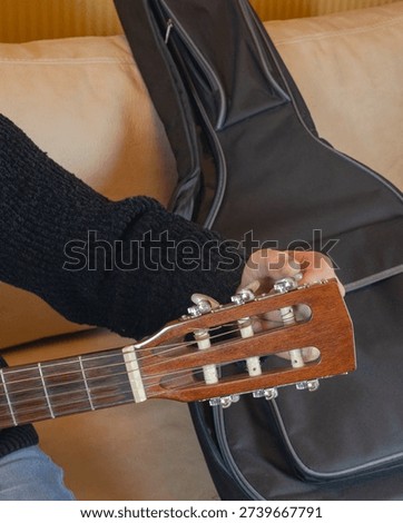 Tuning the fourth string of a classical guitar
