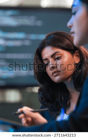 Tuning future AI model behavior. Specialists collaborate late night reviewing performance data stylus points key parameter adjustment needed screen shows complex neural network flow build now.