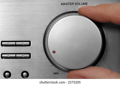 Tuning Knob And Fingers. Silver Radio Close-up.