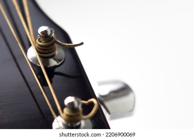 tuning pegs on the fretboard of a guitar close-up