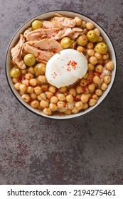 Tunisian Dish Lablabi Or Lablebi Based On Chick Peas In A Thin Garlic And Cumin Broth Topped With A Poached Egg And Tuna Closeup In The Bowl On The Table. Vertical Top View From Above
