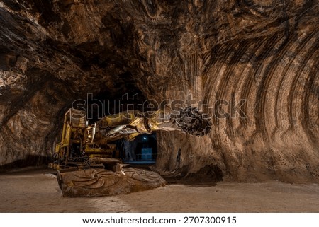 Tunnel boring machine operating inside an underground rocksalt mine in Loulé, Algarve, showcasing heavy mining equipment, rugged mineral walls, and deep-earth excavation engineering