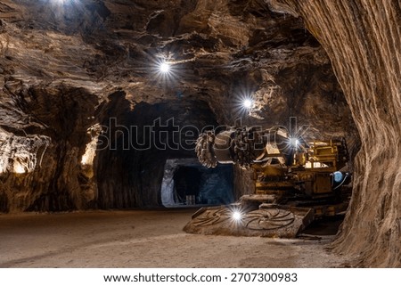 Tunnel boring machine operating inside an underground rocksalt mine in Loulé, Algarve, showcasing heavy mining equipment, rugged mineral walls, and deep-earth excavation engineering