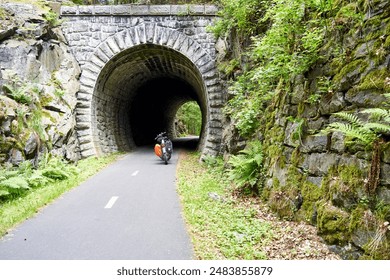 Tunnel on a Former Railway Line in Czechia Converted into a Paved Long-Distance Cycle Path with an E-Fatbike in Front - Powered by Shutterstock