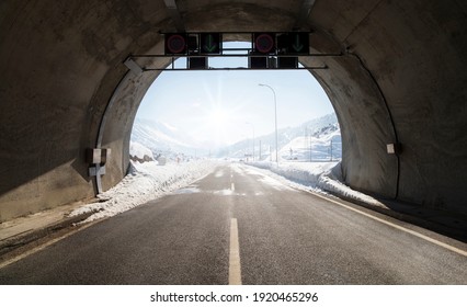 Tunnel Road. Exit From The Tunnel, Snow On The Asphalt Road