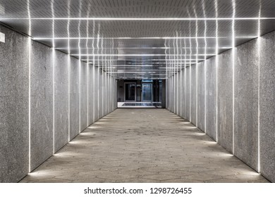 tunnel, underground pedestrian crossing at night. A long concrete tunnel with lanterns in the city underground. Underpass. - Powered by Shutterstock