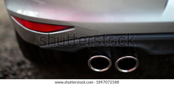 \
turbo exhaust on modern car, dual exhaust\
pipe, car background