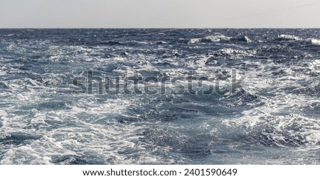 Turbulent flow of a boat wake. Sea wave. The yacht sails, leaving behind a trail and waves.